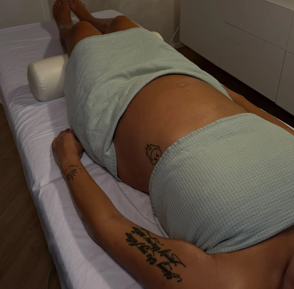 Pregnancy massage at LoriSkin: a mum-to-be lying relaxed on the treatment table